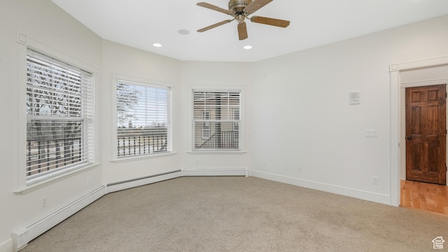 carpeted spare room featuring ceiling fan