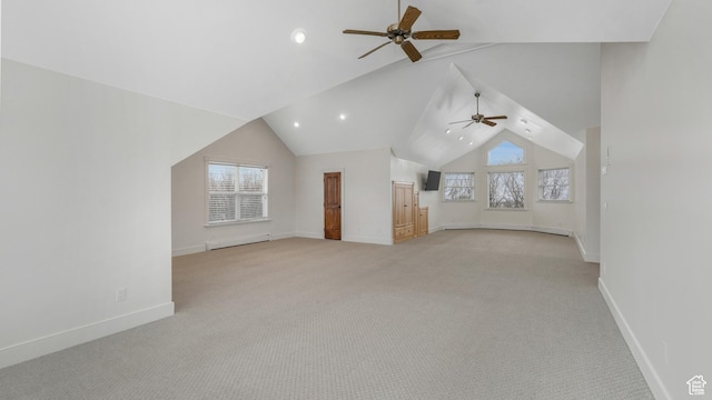 additional living space with baseboard heating, a wealth of natural light, and light colored carpet