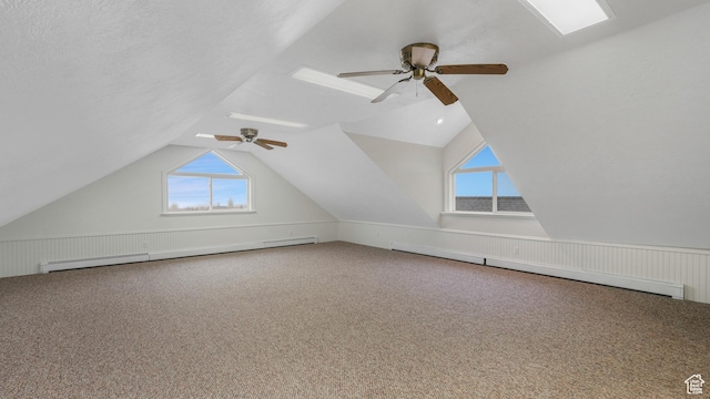 bonus room featuring ceiling fan, vaulted ceiling, carpet floors, and a baseboard radiator