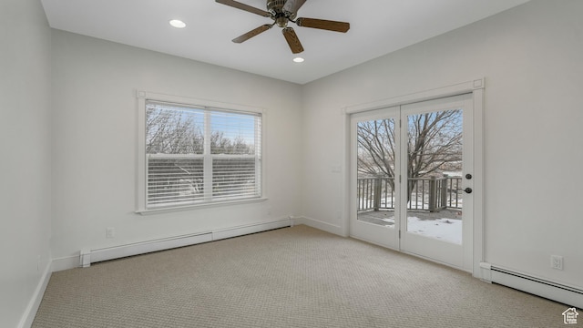 spare room with a baseboard radiator, a wealth of natural light, and ceiling fan