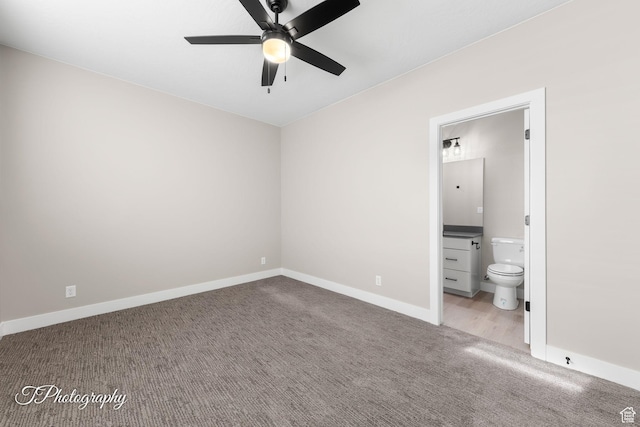 unfurnished bedroom with light colored carpet, ensuite bath, and ceiling fan