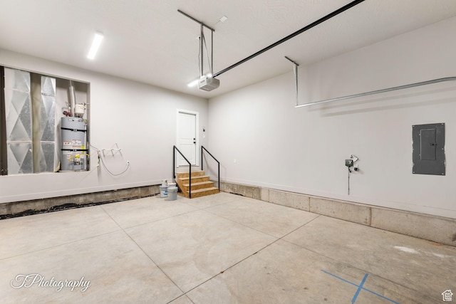 garage featuring strapped water heater, electric panel, and a garage door opener