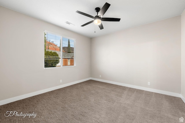carpeted spare room featuring ceiling fan