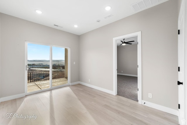 unfurnished room with ceiling fan and light wood-type flooring