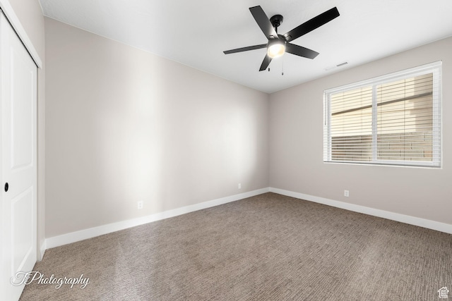 carpeted empty room with ceiling fan