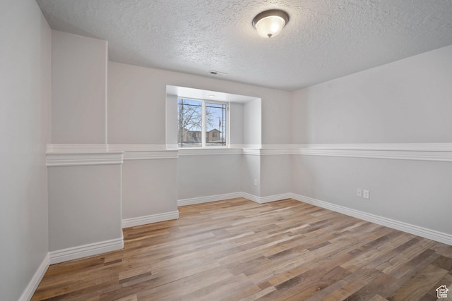 6190 W 5950 S, Hooper, UT 84315 - empty room featuring a textured ceiling and light wood-type flooring