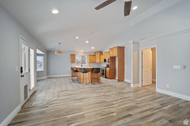 6190 W 5950 S, Hooper, UT 84315 - kitchen featuring ceiling fan, decorative light fixtures, a breakfast bar, a kitchen island, and appliances with stainless steel finishes