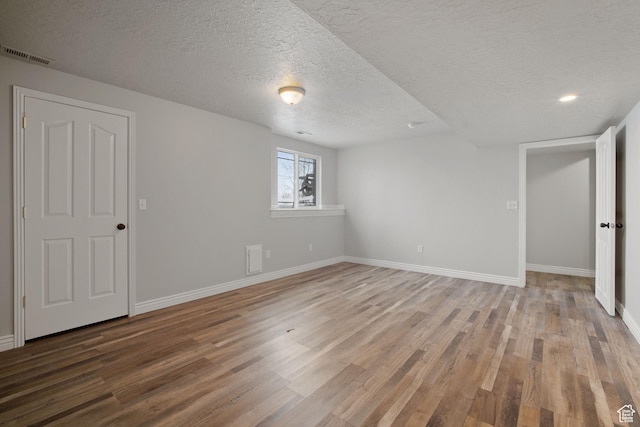 6190 W 5950 S, Hooper, UT 84315 - unfurnished bedroom featuring hardwood / wood-style flooring and a textured ceiling