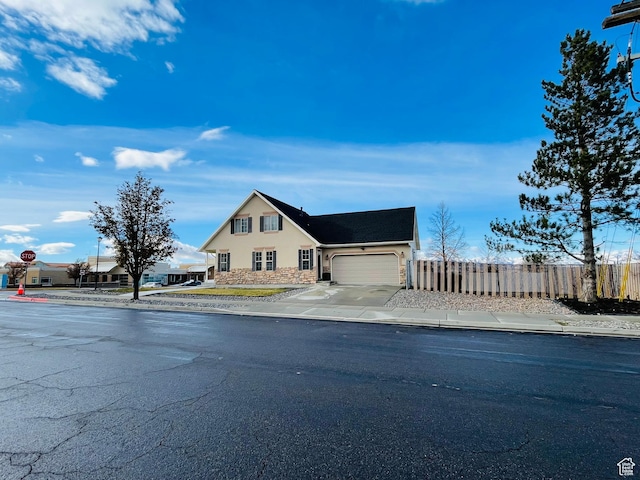 908 W Timpie Rd S, Tooele, UT 84074 - view of front facade featuring stone siding, a garage, stucco siding, and driveway
