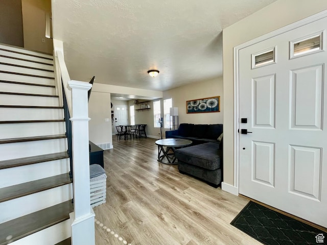 908 W Timpie Rd S, Tooele, UT 84074 - entrance foyer featuring stairs, light wood-style floors, and baseboards