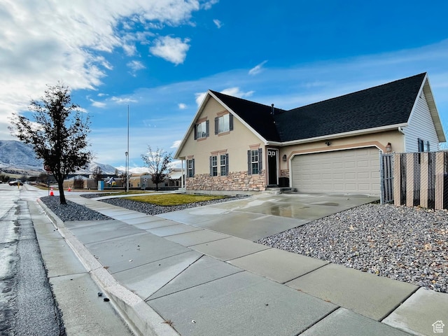 908 W Timpie Rd S, Tooele, UT 84074 - view of front facade featuring stucco siding, a garage, stone siding, driveway, and a shingled roof