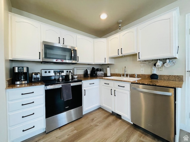 908 W Timpie Rd S, Tooele, UT 84074 - kitchen with stainless steel appliances, a sink, light wood-style flooring, white cabinets, and recessed lighting