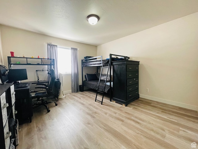 908 W Timpie Rd S, Tooele, UT 84074 - bedroom featuring light wood-style floors, a desk, and baseboards