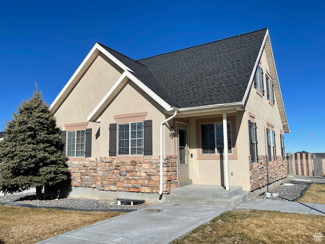 908 W Timpie Rd S, Tooele, UT 84074 - view of front of house with stucco siding, stone siding, and a shingled roof