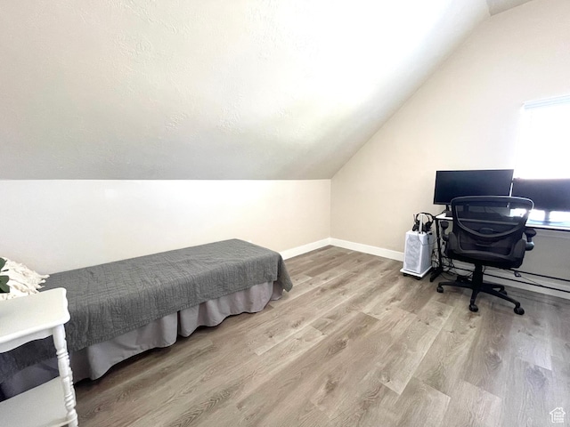 908 W Timpie Rd S, Tooele, UT 84074 - bedroom with vaulted ceiling, wood finished floors, baseboards, and an office area