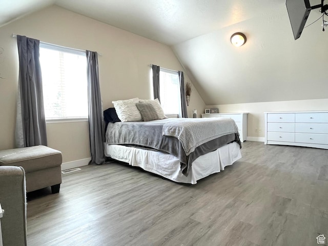 908 W Timpie Rd S, Tooele, UT 84074 - bedroom featuring lofted ceiling, wood finished floors, and baseboards