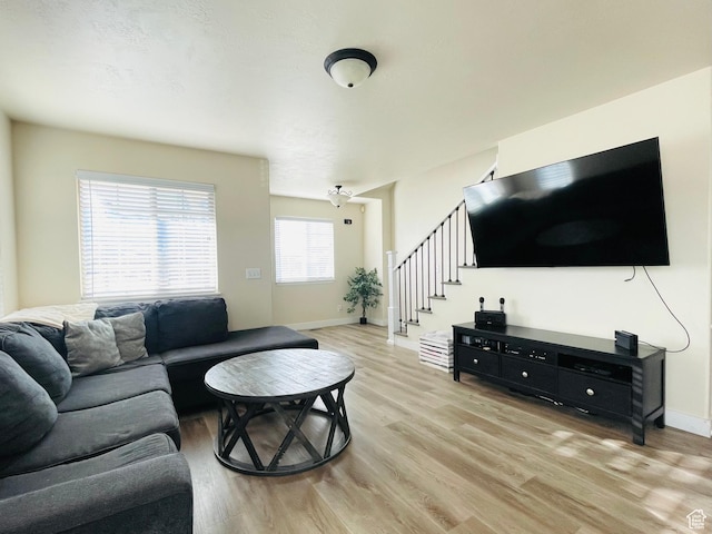 908 W Timpie Rd S, Tooele, UT 84074 - living area with light wood-style flooring, stairs, and baseboards