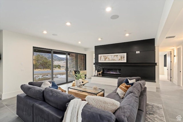 1316 N Gold Mountain Cir, Heber City, UT 84032 - living room featuring baseboards, recessed lighting, and a glass covered fireplace