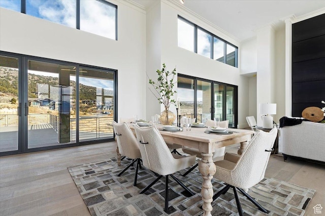 1316 N Gold Mountain Cir, Heber City, UT 84032 - dining room with crown molding, french doors, light wood-type flooring, and a towering ceiling