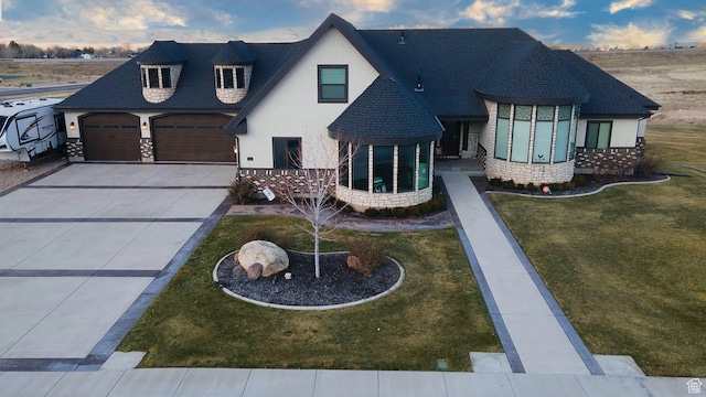 743 N 1100 E, Nephi, UT 84648 - view of front of home featuring a garage, driveway, stone siding, and a front yard