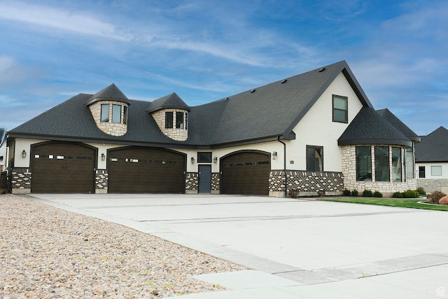 743 N 1100 E, Nephi, UT 84648 - view of front of property featuring stucco siding, an attached garage, driveway, stone siding, and roof with shingles