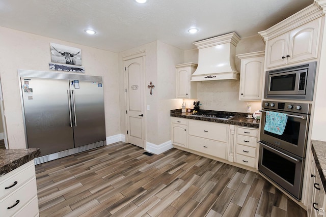 743 N 1100 E, Nephi, UT 84648 - kitchen with recessed lighting, wood finished floors, built in appliances, and custom range hood
