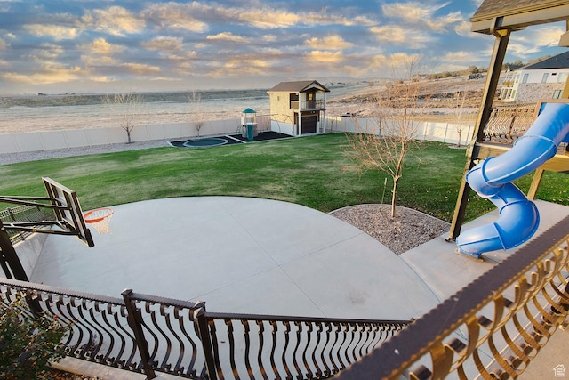 743 N 1100 E, Nephi, UT 84648 - patio terrace at dusk with a lawn, a fenced backyard, a playground, and a water view