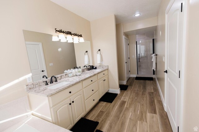743 N 1100 E, Nephi, UT 84648 - bathroom featuring a shower stall, wood finished floors, a sink, double vanity, and baseboards