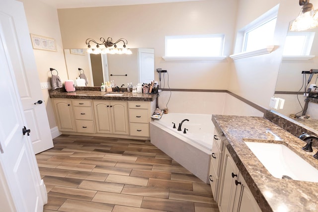743 N 1100 E, Nephi, UT 84648 - full bath with wood tiled floor, two vanities, a garden tub, and a sink