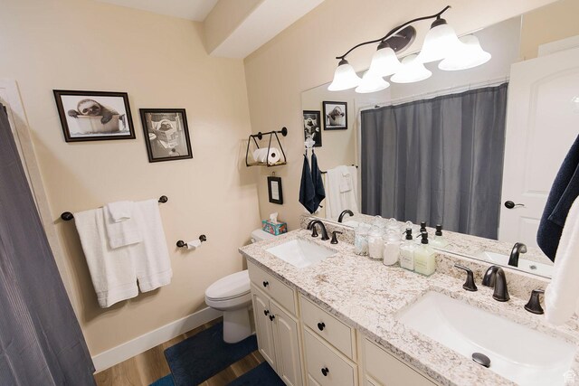 743 N 1100 E, Nephi, UT 84648 - bathroom with wood finished floors, toilet, baseboards, and a sink