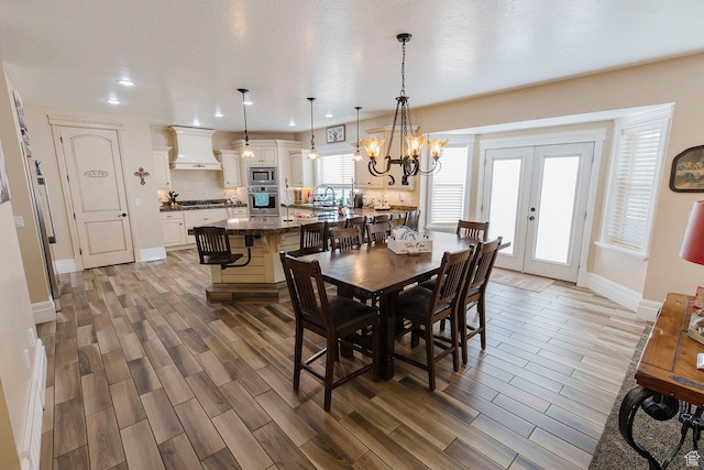 743 N 1100 E, Nephi, UT 84648 - dining space with baseboards, a chandelier, wood tiled floor, and recessed lighting