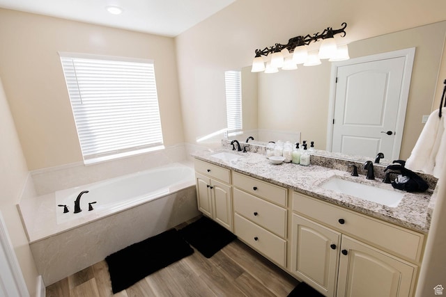 743 N 1100 E, Nephi, UT 84648 - bathroom featuring wood finished floors, a garden tub, and a sink