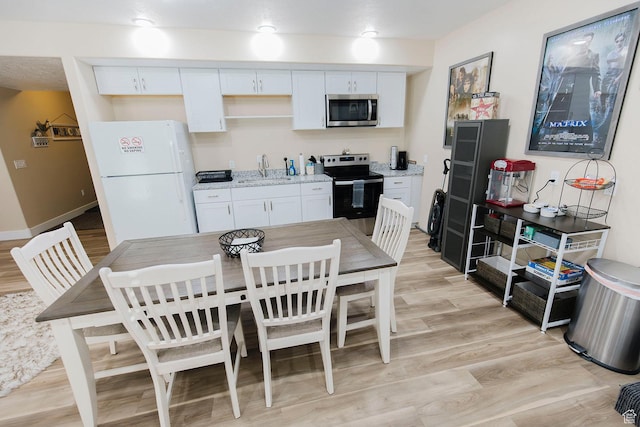 743 N 1100 E, Nephi, UT 84648 - kitchen with light wood-style floors, white cabinetry, stainless steel appliances, and a sink