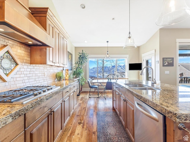 1628 E Viewside Cir, Hideout, UT 84036 - kitchen with sink, decorative backsplash, appliances with stainless steel finishes, custom range hood, and light wood-type flooring