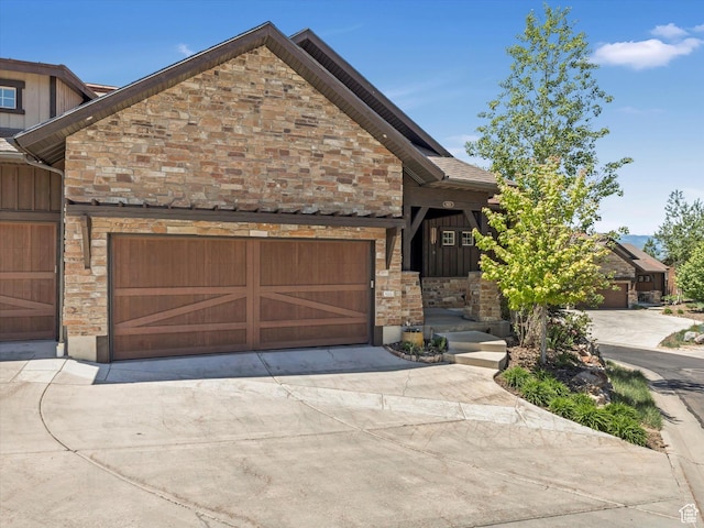 1628 E Viewside Cir, Hideout, UT 84036 - view of front of home with stone siding, driveway, an attached garage, and board and batten siding