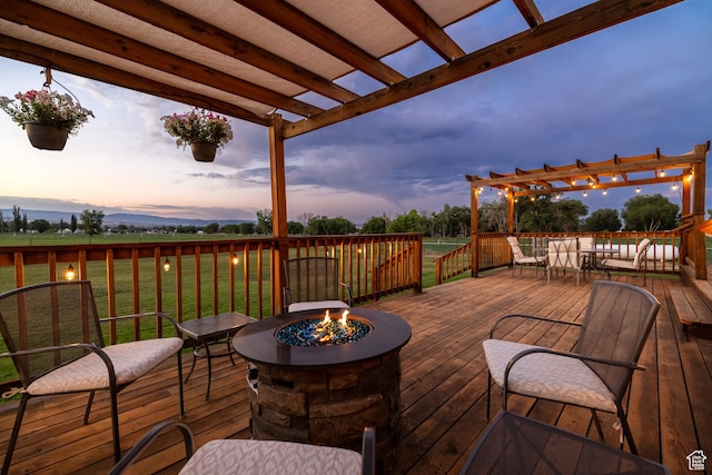 2690 W 500 N, Vernal, UT 84078 - deck at dusk featuring a yard, a pergola, and an outdoor fire pit