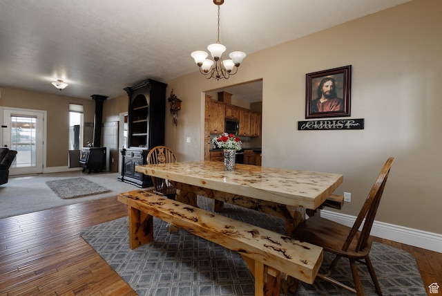 2690 W 500 N, Vernal, UT 84078 - dining space featuring a wood stove, dark hardwood / wood-style flooring, and a notable chandelier