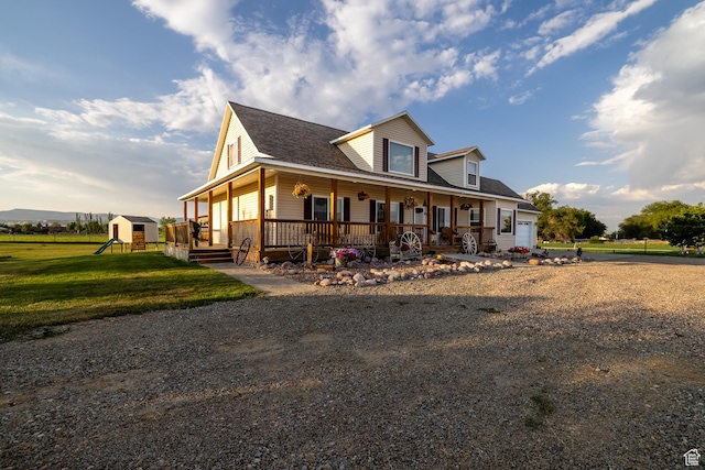 2690 W 500 N, Vernal, UT 84078 - farmhouse-style home featuring a front yard, a porch, a garage, and a storage unit