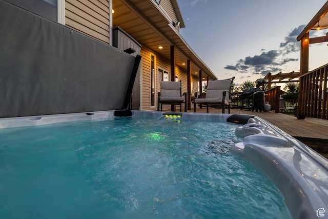 2690 W 500 N, Vernal, UT 84078 - pool at dusk featuring a wooden deck and a hot tub
