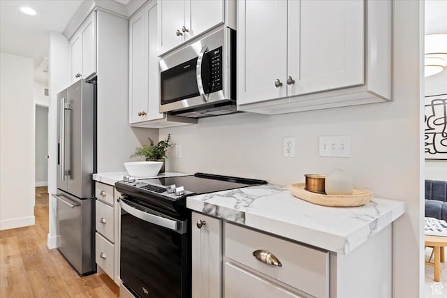 246 E 2100 S, South Salt Lake, UT 84115 - kitchen featuring stainless steel appliances, light wood finished floors, light stone counters, white cabinetry, and recessed lighting