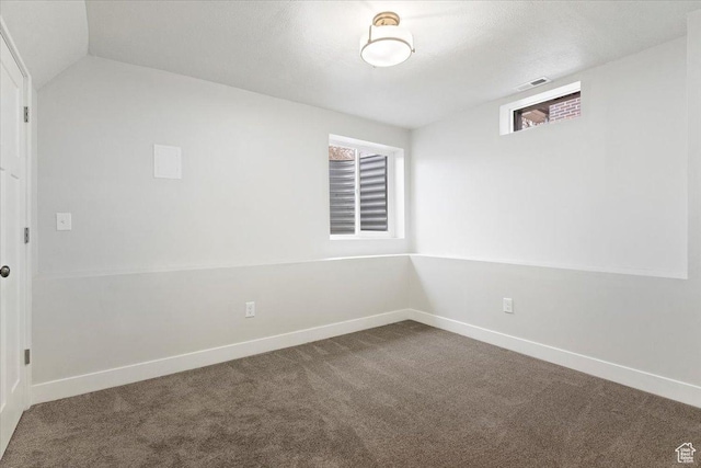 246 E 2100 S, South Salt Lake, UT 84115 - unfurnished room featuring dark colored carpet and vaulted ceiling