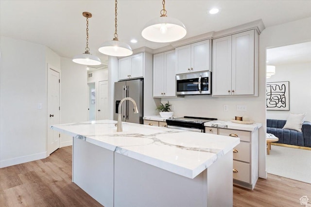 246 E 2100 S, South Salt Lake, UT 84115 - kitchen with stainless steel appliances, light wood-style floors, hanging light fixtures, light stone countertops, and recessed lighting