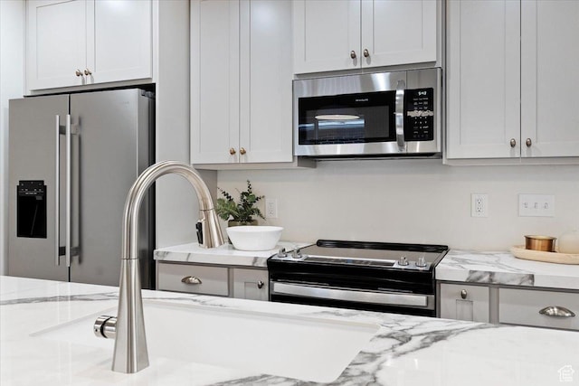 246 E 2100 S, South Salt Lake, UT 84115 - kitchen featuring stainless steel appliances and light stone counters