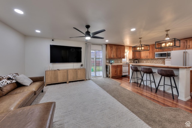 558 Winesap Cir, Moab, UT 84532 - living room with a chandelier, recessed lighting, light wood-style flooring, and ceiling fan