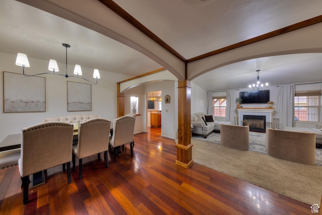 558 Winesap Cir, Moab, UT 84532 - dining area with a chandelier, arched walkways, hardwood / wood-style flooring, healthy amount of natural light, and ornamental molding