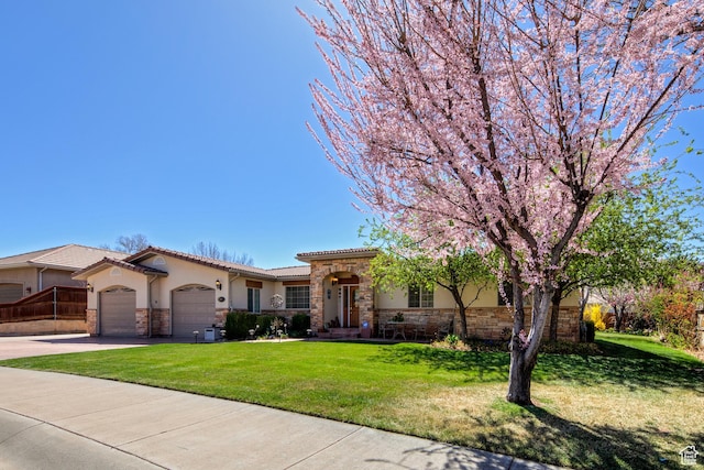 558 Winesap Cir, Moab, UT 84532 - view of front of house featuring stone siding, stucco siding, a garage, and a front lawn
