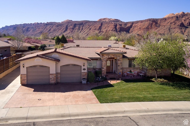 558 Winesap Cir, Moab, UT 84532 - mediterranean / spanish house with stone siding, stucco siding, a garage, and driveway