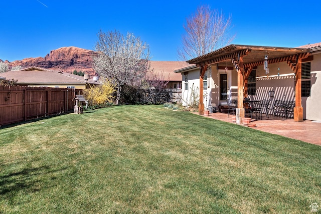 558 Winesap Cir, Moab, UT 84532 - fenced backyard featuring a patio area, a pergola, and a mountain view