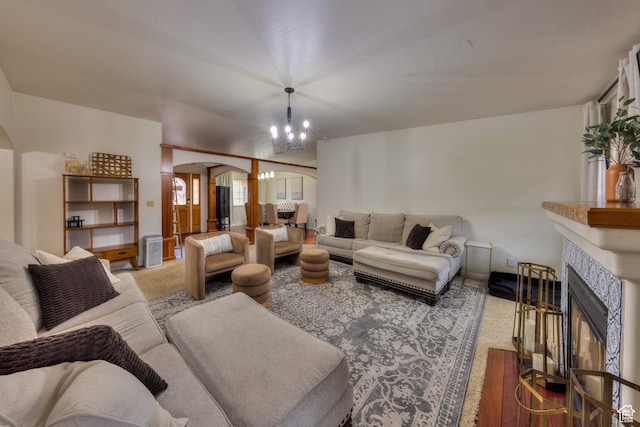 558 Winesap Cir, Moab, UT 84532 - living area featuring arched walkways, a fireplace, carpet floors, and a chandelier