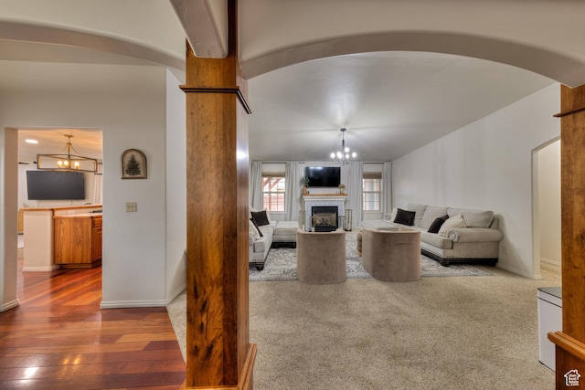 558 Winesap Cir, Moab, UT 84532 - living room featuring a fireplace, arched walkways, wood finished floors, and vaulted ceiling